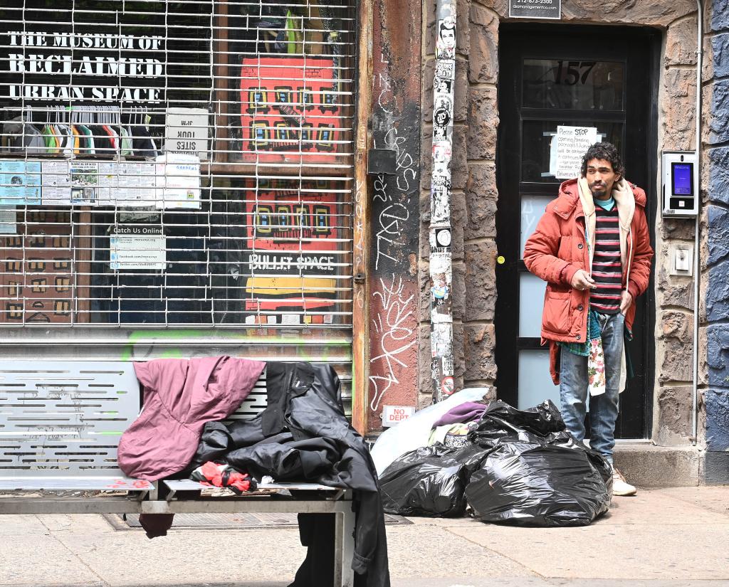 Nicholas Babilonia standing in a doorway with garbage 