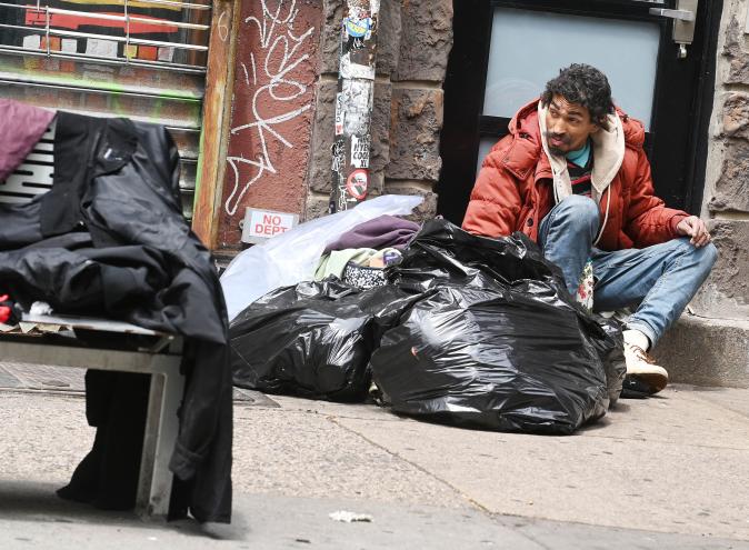 Nicholas Babilonia Jr. surrounded by garbage