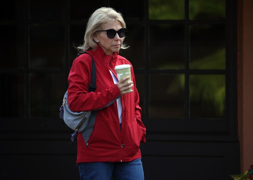 Shari Redstone walking in a red vest.