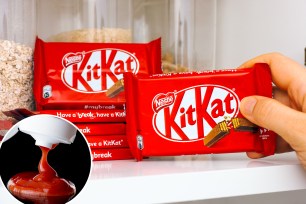 Tambov, Russian Federation - March 19, 2021 Woman hand taking KitKat chocolate bar by Nestle from shelf of kitchen cupboard
