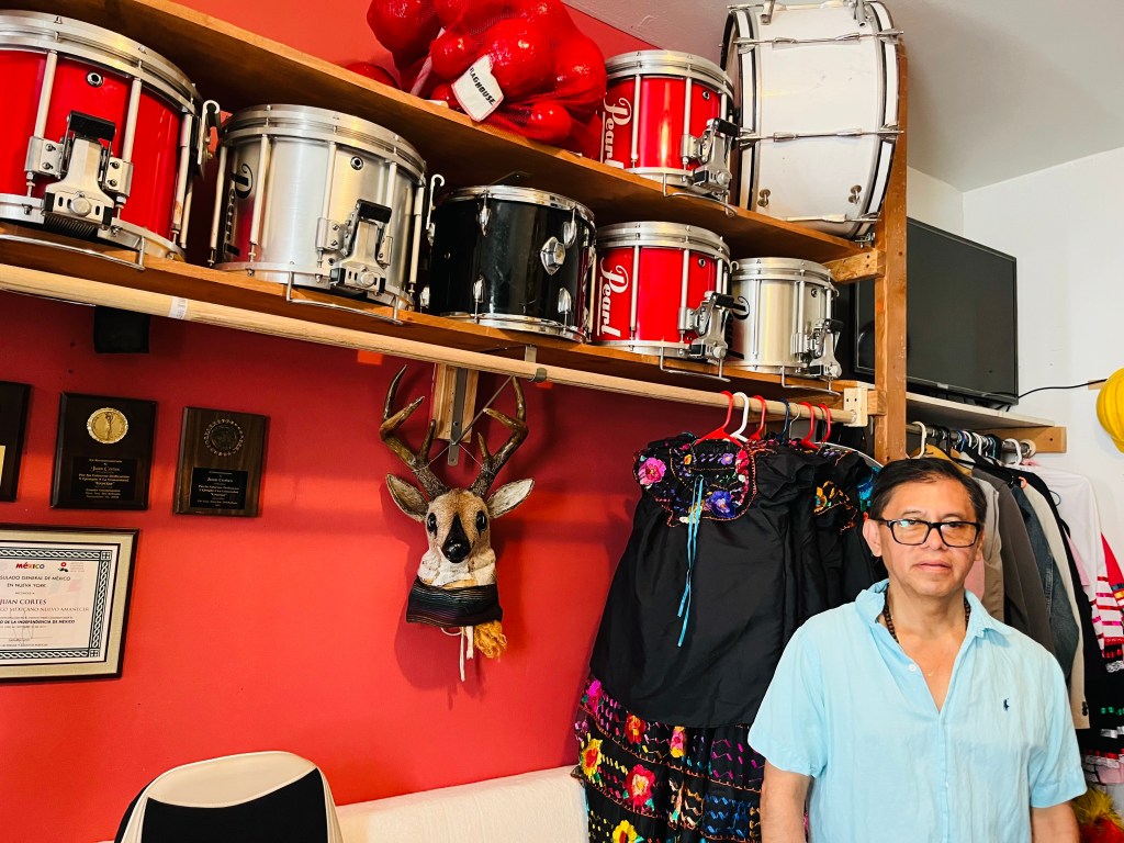 Cortes Cabrera standing with some of the instruments he uses in his classes. 
