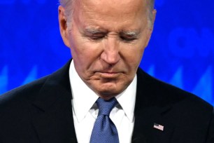 President Joe Biden looks down as he participates in the first presidential debate of the 2024 elections with former US President and Republican presidential candidate Donald Trump at CNN's studios in Atlanta, Georgia.