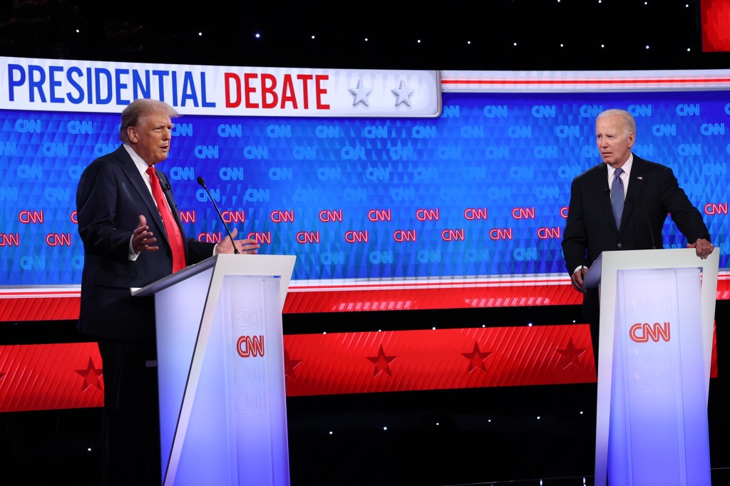 U.S. President Joe Biden and former President Donald Trump participating in the CNN Presidential Debate at a podium in Atlanta, Georgia on June 27, 2024