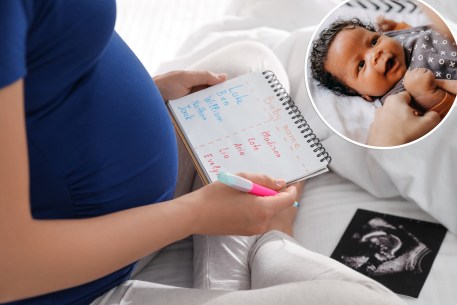 pregnant woman with list of baby names and baby