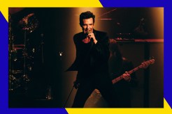 Brandon Flowers sings in concert.