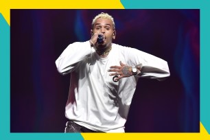 Chris Brown sings onstage.