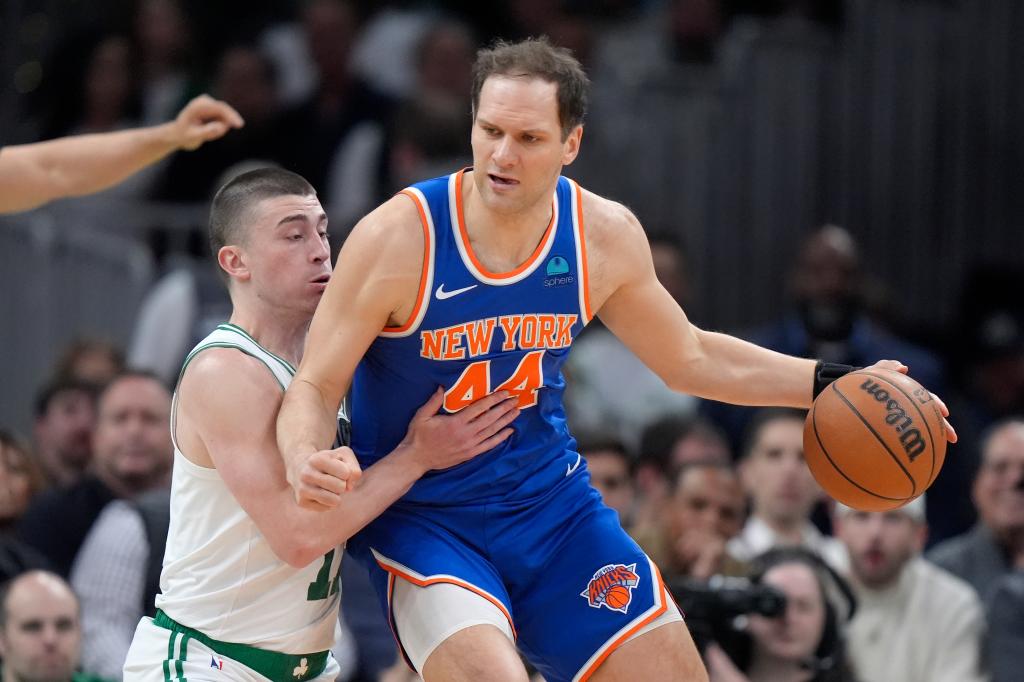 New York Knicks forward Bojan Bogdanovic (44) drives against Boston Celtics guard Payton Pritchard (11) during the first half of an NBA basketball game Thursday, April 11, 2024, in Boston. 