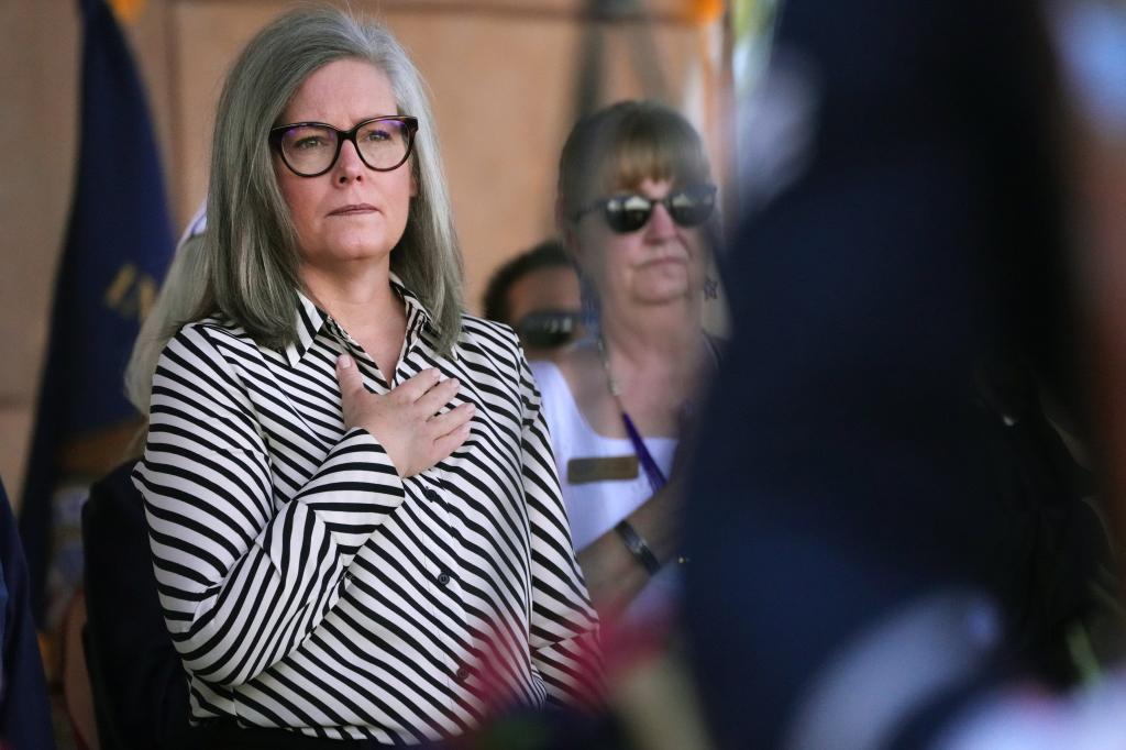 Gov. Katie Hobbs stands for the Pledge of Allegiance as people gather for a Memorial Day ceremony entitled Ã¢â¬ÅHome of the BraveÃ¢â¬Â at the VA National Memorial Cemetery of Arizona on May 27, 2024, in Phoenix.