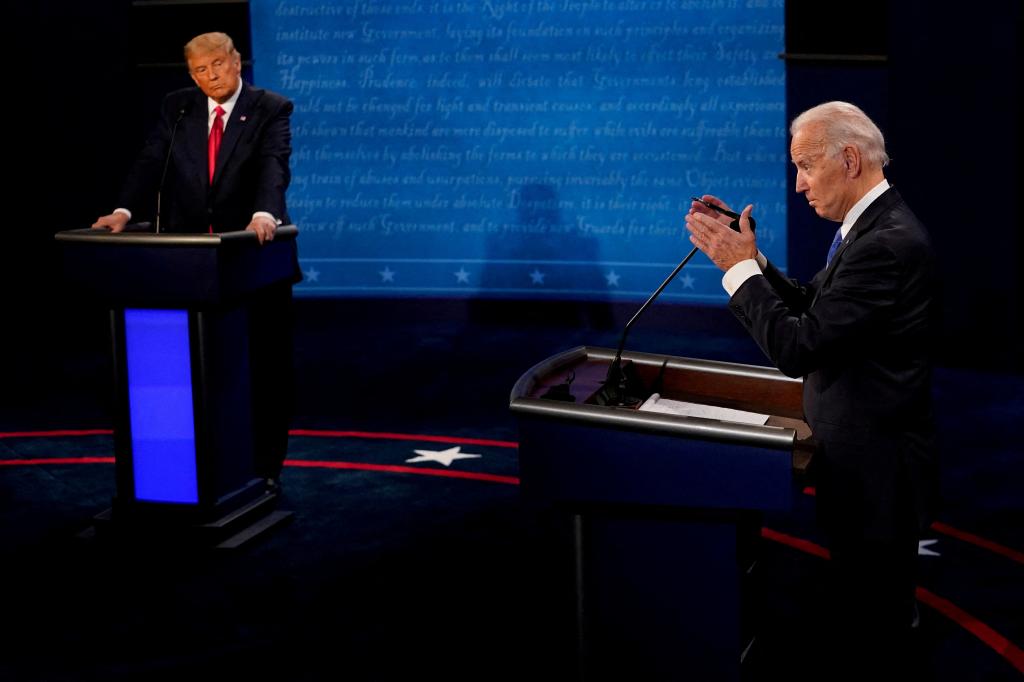 Biden and Trump are seen listening during the second and final presidential debate in Nashville, Tennessee on October 22, 2020.
