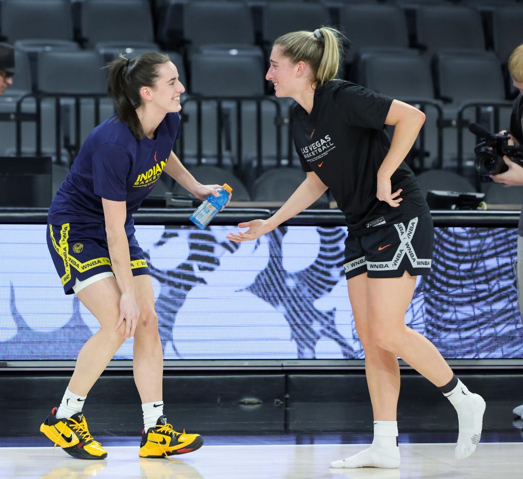 Former Iowa Hawkeyes teammates Caitlin Clark (L) #22 of the Indiana Fever and Kate Martin #20 of the Las Vegas Aces greet each other on the court during warmups before their game at Michelob ULTRA Arena on May 25, 2024 in Las Vegas, Nevada.