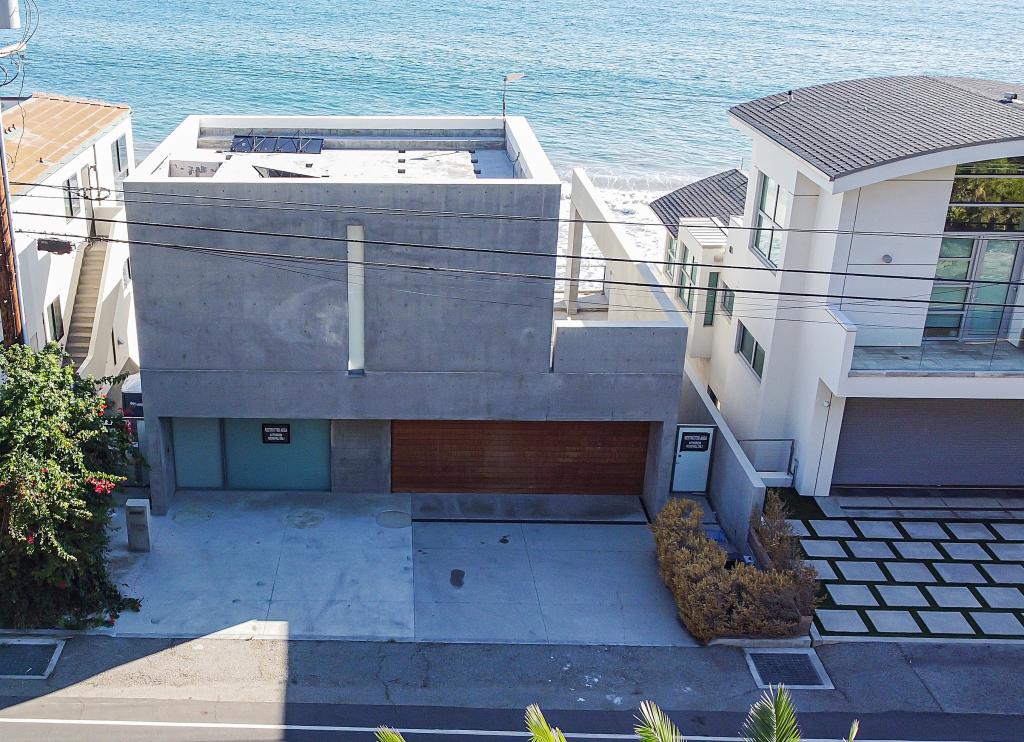 The three-story house on Puerco Beach was built on a 0.13-acre beachfront in 2013. It has a large, glass pivot door facing the beach, a garage, four bedrooms and five bathrooms, city records show.