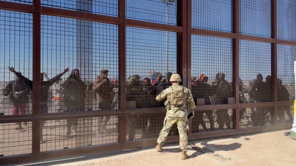 Migrants battle with National Guard soldiers at the border during the March 21 riot at El Paso's gate 36