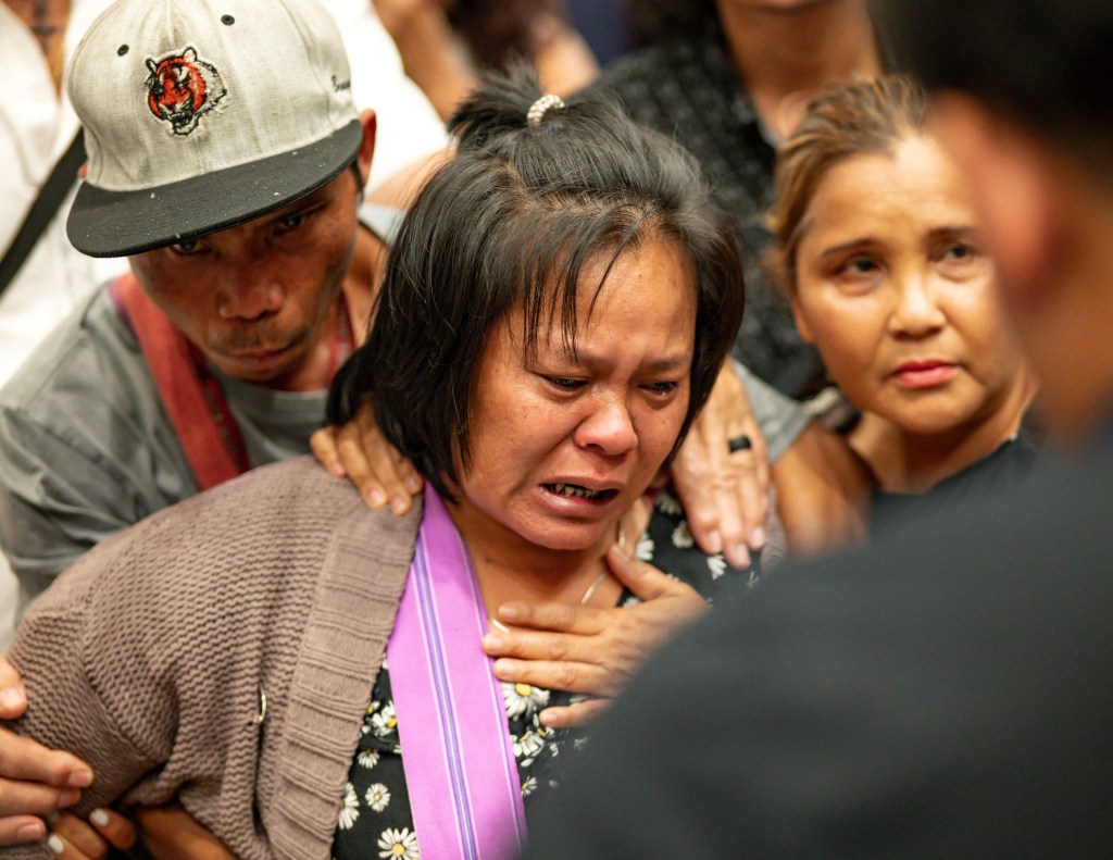 The mother of the 13 year old boy who was shot and killed by Utica Police cries after listening to a translator inside City Hall in Utica