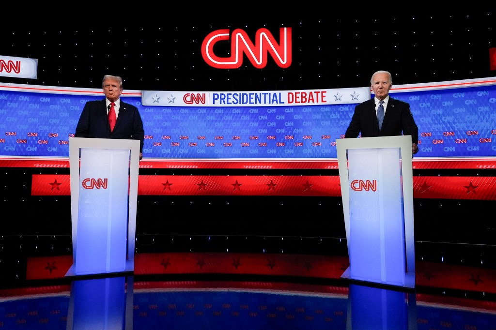 President Joe Biden and former President Donald Trump standing at podiums during a break in the 2024 presidential debate in Atlanta