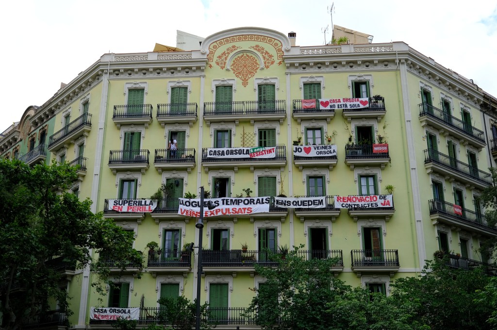 Casa Orsola, an apartment building is decorated with banners calling out the investment company that bought out the building, which has become a symbol of the city's real estate crisis on June 24, 2024.