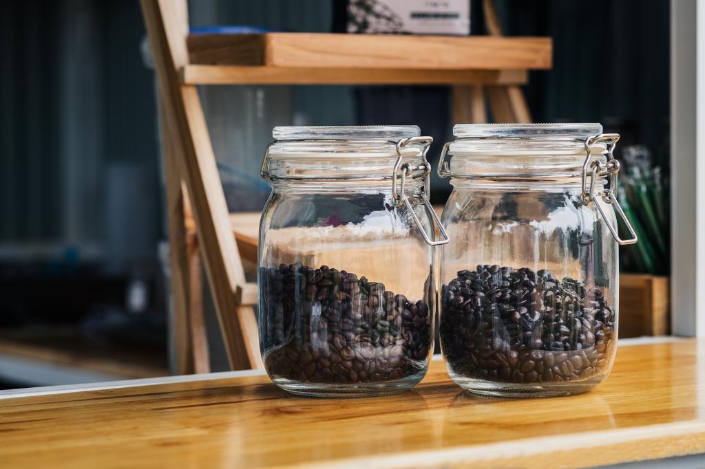 Two glass jars filled with roasted coffee beans