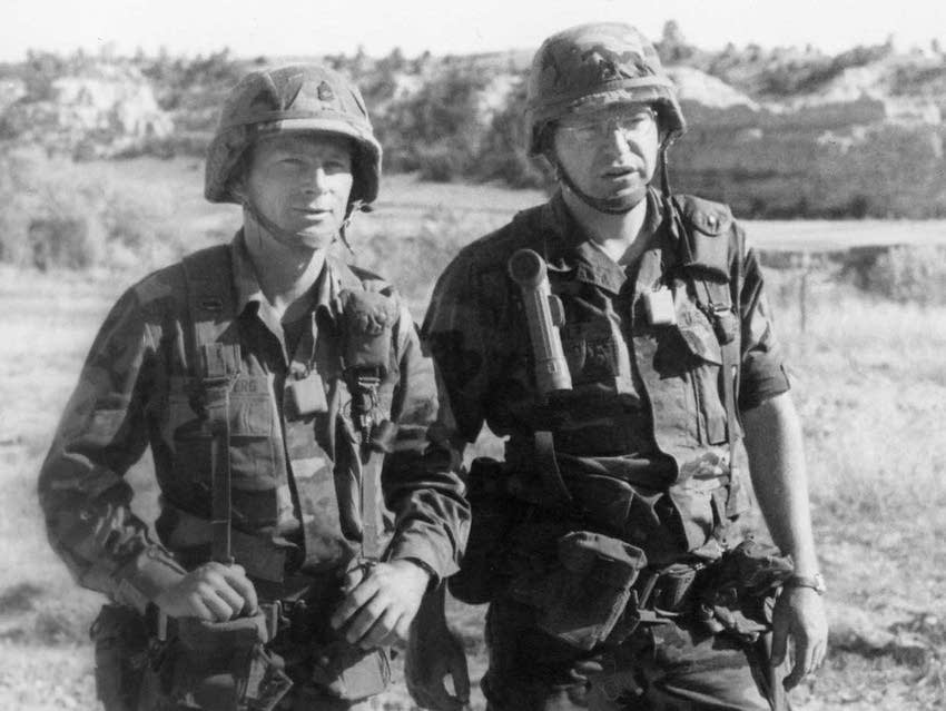 Tim Walz, right, and Gary Bloomberg, wearing helmets and combat attire.