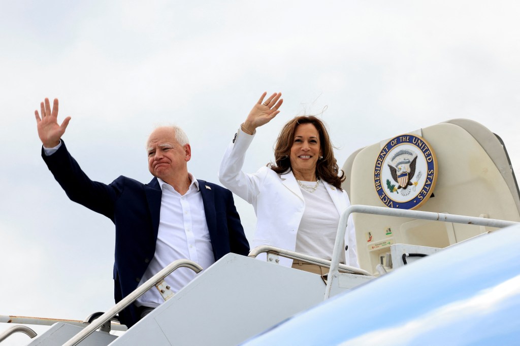 Tim Walz and Kamala Harris waving before getting on the vice presidential plane.