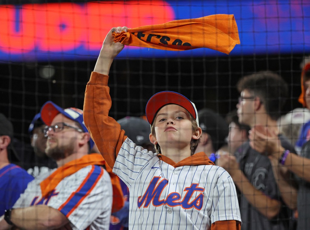 A young fan waves his towel during the sixth inning of Game 3.