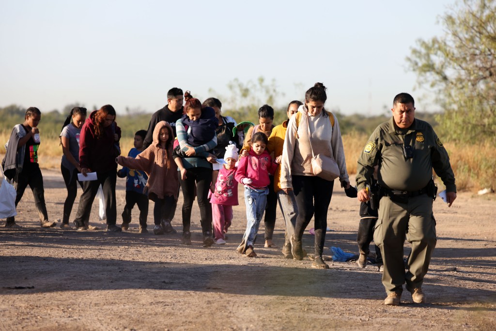 A group of migrants crosses into the US through Eagle Pass, Texas.