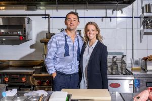 Man and woman in business attire in a kitchen