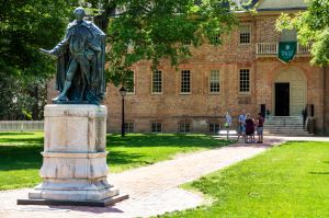 Statue placed in quad of school, large brick building behind