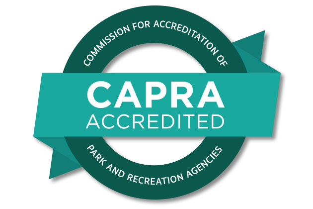 Capra logo in a circle with a ribbon