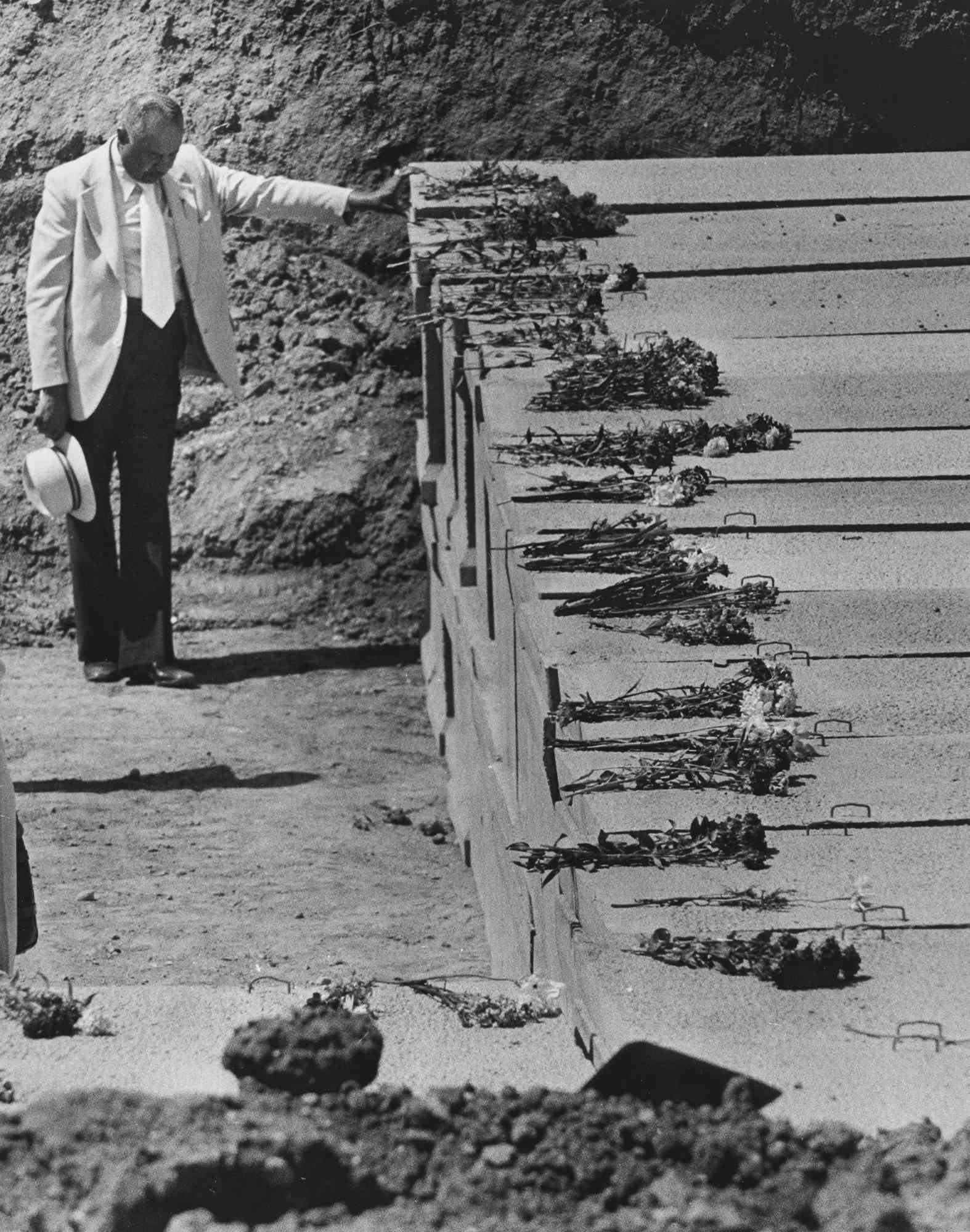 A mourner reflects in a moment of prayer before the burial of Jonestown victims at Evergreen Cemetery in Oakland, California on May 24, 1979.