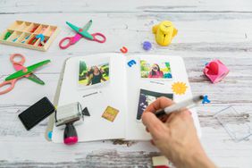 female hand writing in a photo journal