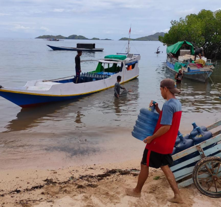 Man carries water to a boat