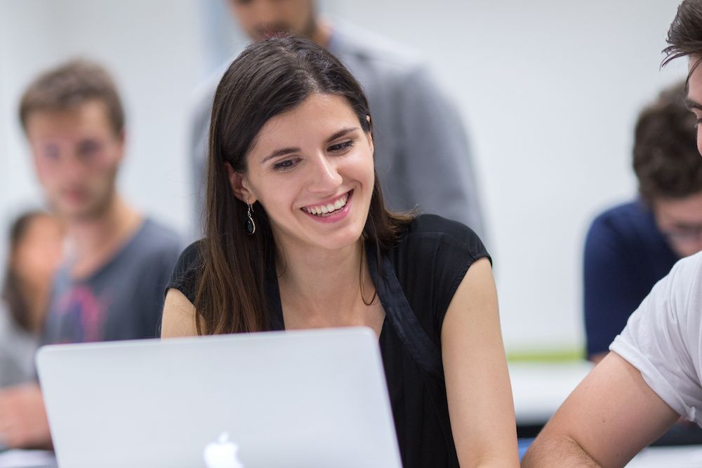 Student looking at laptop smiling