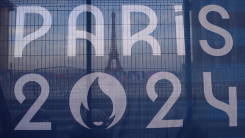 The Eiffel Tower is seen behind a Paris Olympics canvas, from the Trocadero plaza Thursday, July 18, 2024 in Paris.