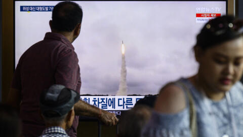 A man watches a television screen showing a news broadcast with file footage of a North Korean missile test, at a train station in Seoul on September 18, 2024.