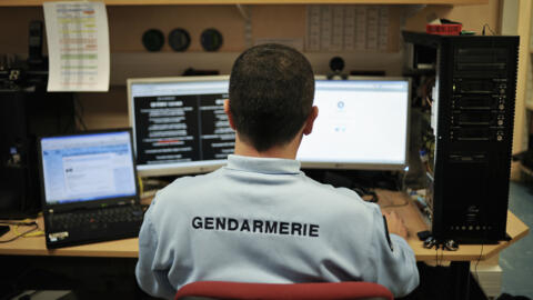 [File photo] A French police officer and member of the cybercrime squad in Dijon works at his desk on February 21, 2011. 