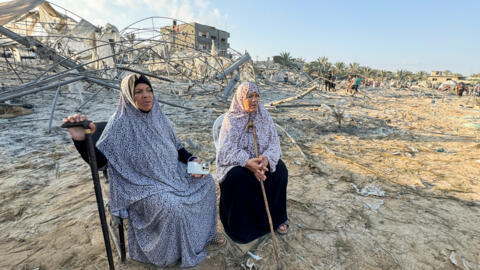 Palestinian women sit at the site following Israeli strikes on a tent camp sheltering displaced people at the Al-Mawasi area in Khan Younis, in the southern Gaza Strip, September 10, 2024.