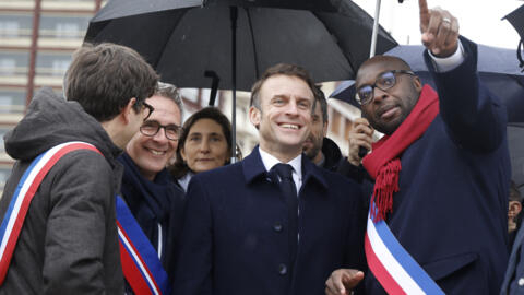 Île-Saint-Denis mayor Mohamed Gnabaly speaks with Macron during the inauguration of the Paris 2024 Olympic village in Saint-Denis, on February 29, 2024.