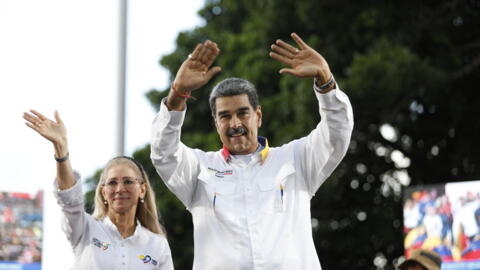 Venezuelan President Nicolas Maduro greets supporters next to first lady Cilia Flores during a rally in Caracas on August 3, 2024.