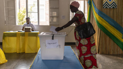 A voter casts her ballot at a polling station in Kigali, on July 15, 2024, during Rwanda's presidential and parliamentary elections.