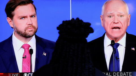 A screen shows Republican vice presidential nominee US Senator JD Vance (R-OH) and Democratic vice presidential nominee Minnesota Governor Tim Walz attending a debate hosted by CBS in New York, US, Oc