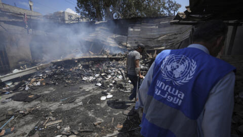 [File photo] Palestinians look at the destruction after an Israeli strike hit an UNRWA-run school in Nuseirat, Gaza Strip, on May 14, 2024.