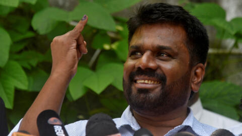 Anura Kumara Dissanayake, the presidential candidate from National People's Power, shows his ink-marked finger after casting his vote at a polling station, September 21, 2024.