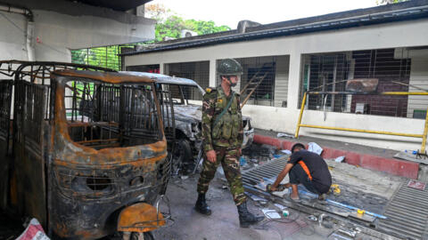 Charred vehicles are pictured at the state broadcaster Bangladesh Television, after students set it on fire during the anti-quota protest, in Dhaka on July 24, 2024.