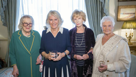 Irish writer Edna O’Brien (2R) stands next to actress Judy Dench (R), British writer Antonia Fraser (L) and Camilla, then Duchess of Cornwall (2L), at a reception in London on October 26, 2021.