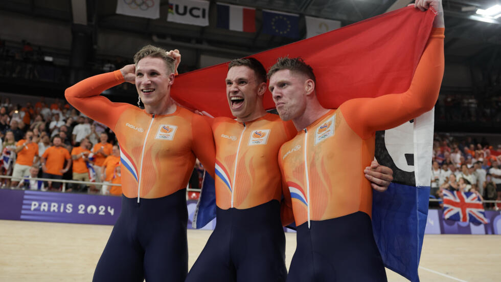 The Netherlands' Jeffrey Hoogland, Harrie Lavreysen and Roy van den Berg celebrate after winning the men's team sprint gold