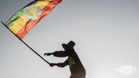 A man waves an Ethiopian flag as he join others gathering in Addis Ababa, Ethiopia, on October 22, 2022.