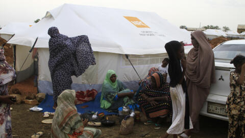 Women and children outside their tent at a camp for internally displaced at Gedaref in east Sudan.