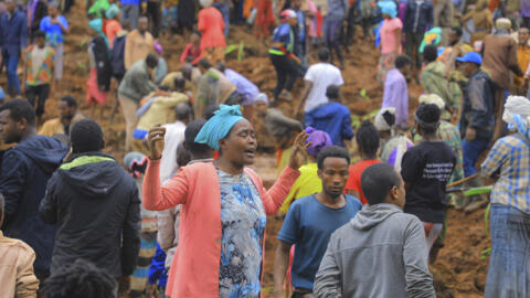 Hundreds of people gather at the site of a mudslide in the Kencho Shacha Gozdi district, Gofa Zone, southern Ethiopia, Monday, July 22, 2024.