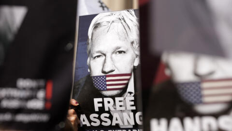 Protesters hold placards in support of WikiLeaks founder Julian Assange outside the High Court in London, Monday, May 20, 2024.