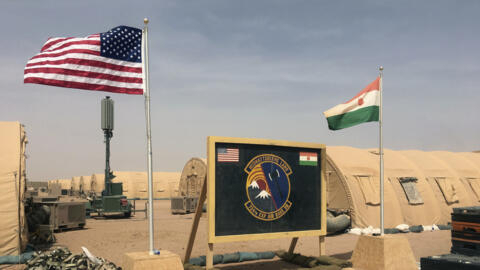 This photo taken Monday, April 16, 2018 shows a US and Niger flag are raised side by side at a base camp for air forces and other personnel  in Agadez, Niger.