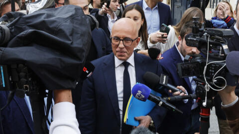 Former leader of Les Republicains party Eric Ciotti (C) walks outside the National Assembly in Paris on June 11, 2024 following the results of the June 9 European Parliament elections.